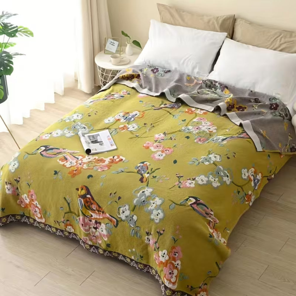 Decorative boho-style patchwork throw with floral and bird motifs